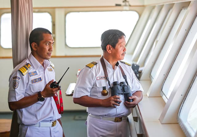 MEMANDU KAPAL: Sutaji (kiri), petugas pandu, didampingi nakhoda kapal Kapten Labani di dalam KM Nggapulu yang akan sandar di Pelabuhan Tanjung Perak. (Alfian Rizal/Jawa Pos) - Image